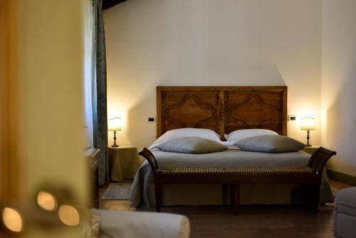 a bedroom with a bed with two pillows on it at Dimora Storica La Corte Delle 4 Stagioni in Ozzano Monferrato