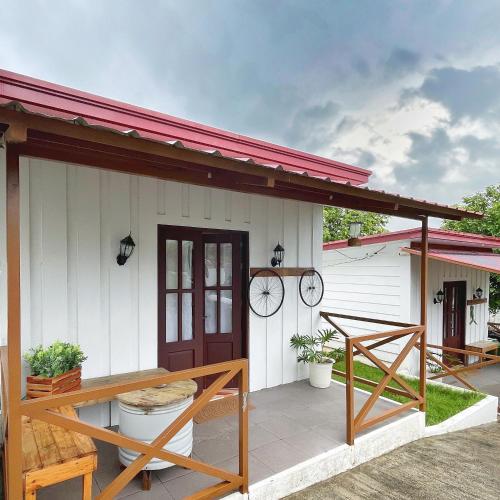 a small white house with a red roof at Casa de Myra in Palayan City