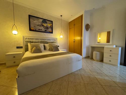 a bedroom with a large bed in a room at Ramo house Central Comfort with Views in Chefchaouen