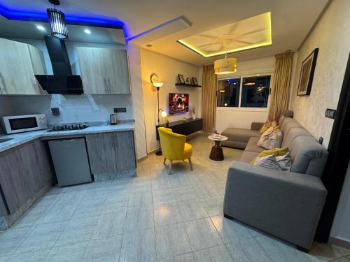 a living room with a couch and a kitchen at Ramo house Central Comfort with Views in Chefchaouen