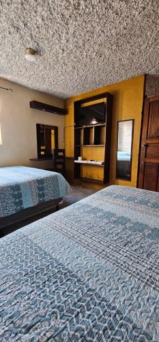 a hotel room with two beds in a room at EL MIRADOR dlr HR in Quetzaltenango