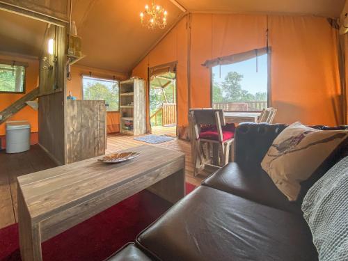 a living room with a couch and a table at Pheasant Lodge in Pangbourne