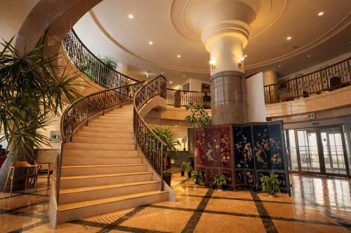 a spiral staircase in a building with plants at 天海の城 in Saikai