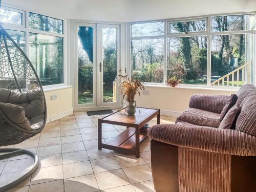 a living room with a couch and a table at Gokula House in Cockermouth