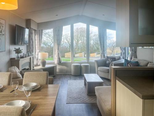 a living room with a couch and a table at Bluebell Lodge - Uk51382 in Wigton