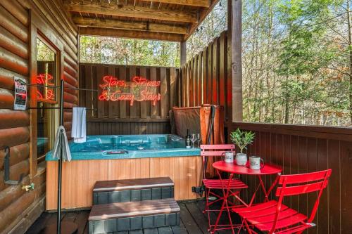 a hot tub on a deck with a table and chairs at 15 min Dollywood, Game room, Hot tub, Shared pool, Pets Welcome in Pigeon Forge