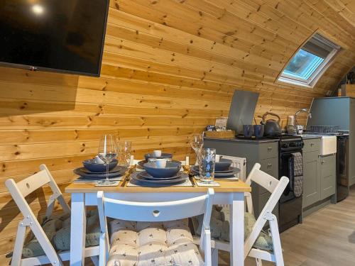 a dining room with a table and chairs in a kitchen at Swallow - Uk51347 in Draughton
