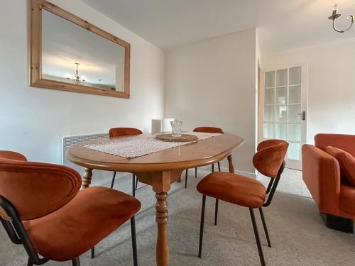 a dining room with a wooden table and chairs at Sea View Apartment in Anstruther