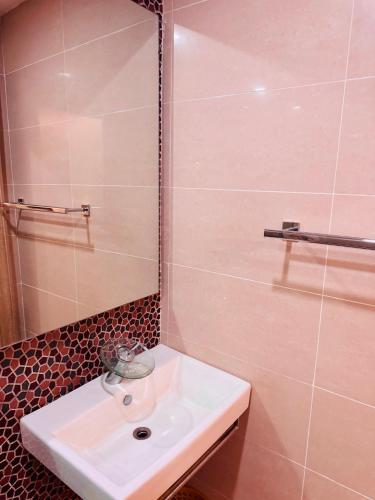 a bathroom with a sink and a shower at Liberty Suite - Abuja in Abuja