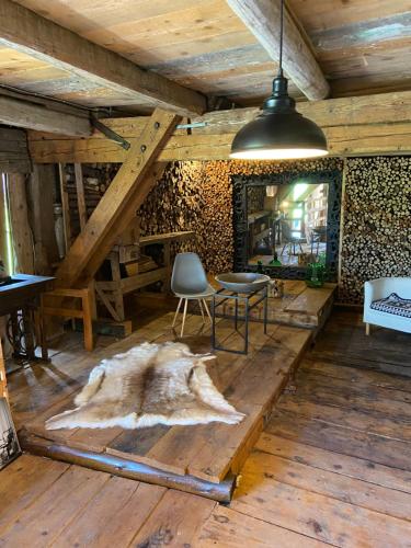 a room with a table and chairs on a wooden floor at Allgäu Cottage - traumhafter Blick in die Schweizer Berge in Weiler-Simmerberg