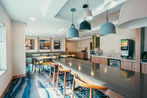 a kitchen with a long table and chairs at Fairfield Inn & Suites by Marriott Atlanta Kennesaw in Kennesaw
