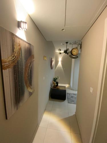 a hallway with a clock on the wall at Nuchiii residence in Dubai