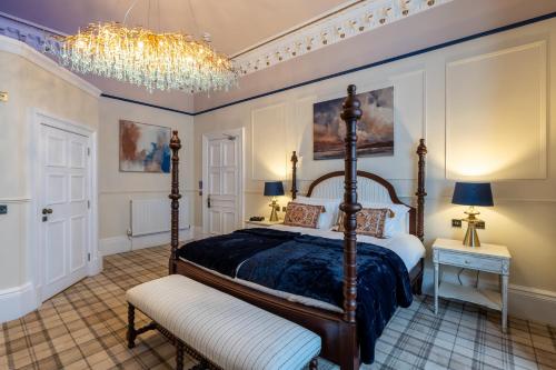 a bedroom with a four poster bed and a chandelier at The Gifford in Edinburgh