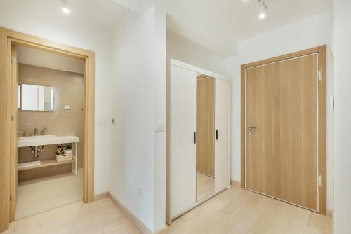 a bathroom with a sliding door and a sink at Azure Bay in Igalo
