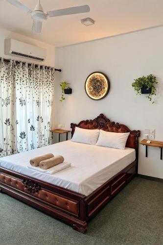 a bedroom with a large bed with white sheets at Wild Pulse Yala in Tissamaharama