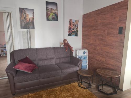 a living room with a couch and two stools at Diana Apartments in Klingenthal