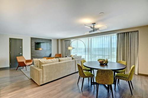 a living room with a couch and a table at Tulsa Marriott Southern Hills in Tulsa