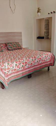 a large bed in a bedroom with a bedspread on it at Tara pushkar in Pushkar