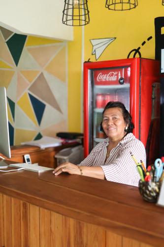 a woman sitting at a counter with a computer at Hostel, Café & Garden Travelers in Santiago