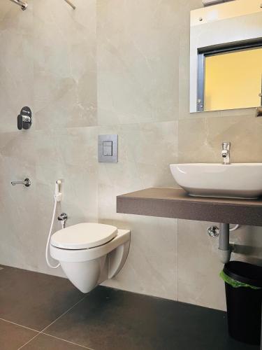 a bathroom with a toilet and a sink at Hill View Heights Wayanad in Meppādi