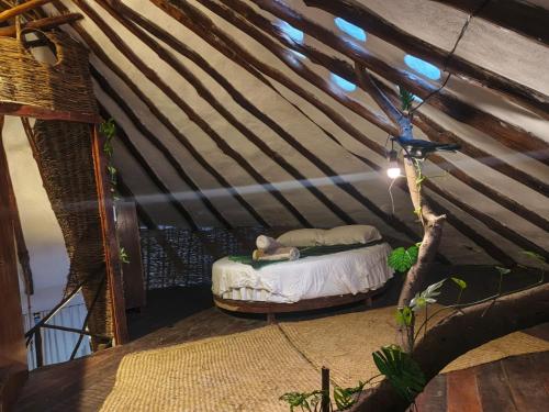 a room with a bed in a tent at Casa caracol Macario in Macario Gomez