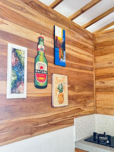 a bottle of beer on the wall of a kitchen at The Lauk private in Gili Islands