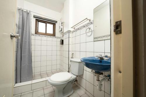 a bathroom with a toilet and a sink at 3BR The South Drive Loft 301 in Baguio