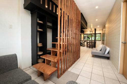 a living room with a staircase in a house at 3BR The South Drive Loft 301 in Baguio