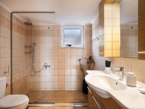 a bathroom with a toilet and a sink and a shower at Casa Horizon in Palaiochora