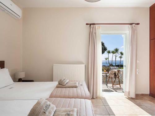 a bedroom with a bed and a view of the ocean at Casa Horizon in Palaiochora