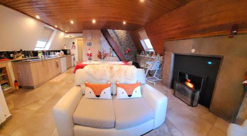 a living room with two chairs and a fireplace at Chalé Zimbro, Serra da Estrela, Penhas da Saúde in Penhas da Saúde