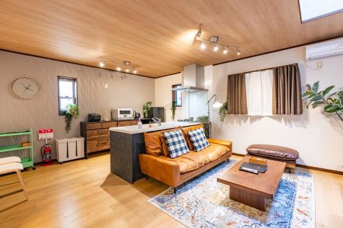 a living room with a couch and a table at NIKYO Senzo Villa Private Villa OSAKA in Osaka