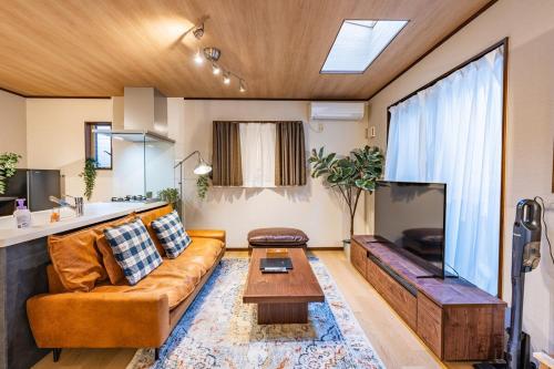 a living room with a couch and a table at NIKYO Senzo Villa Private Villa OSAKA in Osaka