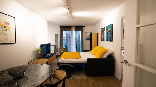 a small room with a bed and a table at Sky One La Defense in Courbevoie