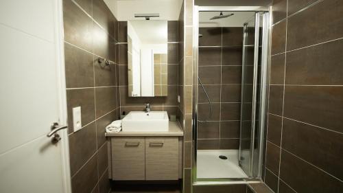 a bathroom with a sink and a shower at Sky One La Defense in Courbevoie