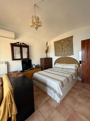 a bedroom with a large bed and a television at CapSaSalBegur74 Terraza sobre Mar, Piscina del Mar in Begur