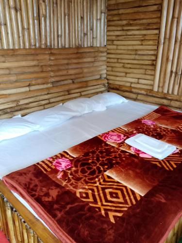 a bed in a wooden room with at Meghh Minar Homestay Sillery Gaon in Kalimpong