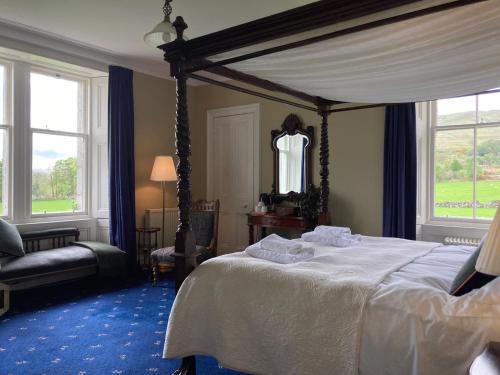 a bedroom with a bed and a chair and windows at Blarcreen in Oban
