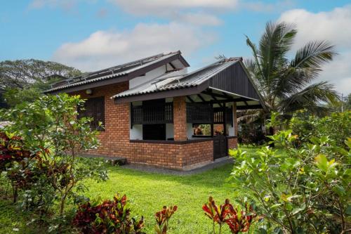 a brick house with a black roof at Karanda Eco Resort in Dambulla