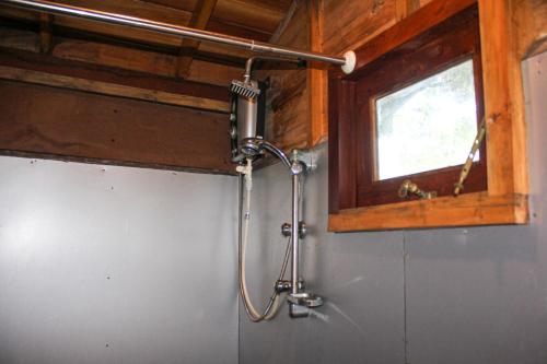 a shower in a bathroom with a window at Matara Eco Friendly Treehouse in Matara