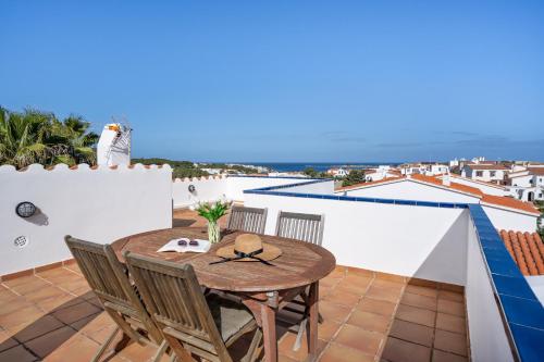 a table on a balcony with a view of the ocean at Villa Sea Garden Holidays by 3VILLAS in Port d'Addaia