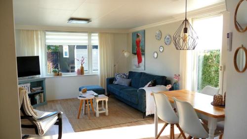 a living room with a blue couch and a table at CHALET36 in GROU in Grou