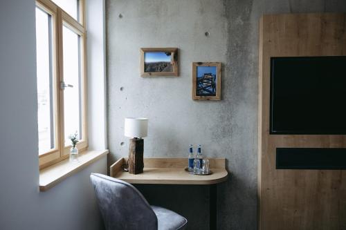 a room with a table and a chair and a television at Grünbauer - Der Landgasthof in Reuth bei Erbendorf