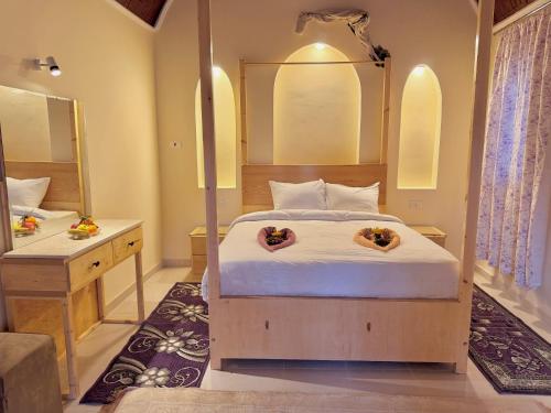 a bedroom with a bed and a large mirror at Talia gust house in Al Aqālitah