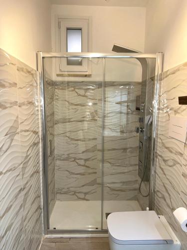 a bathroom with a glass shower with a toilet at Residenza Ohana in Isernia