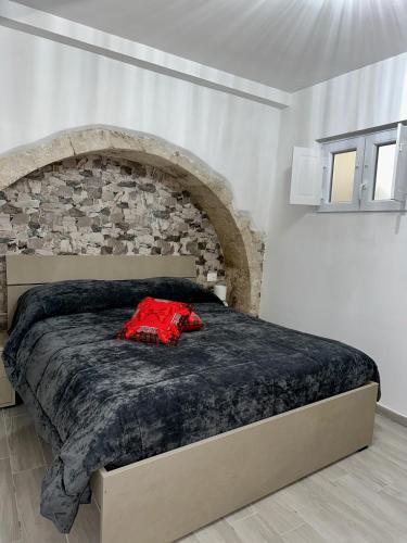 a bedroom with a large bed with a stone wall at Residenza Ohana in Isernia