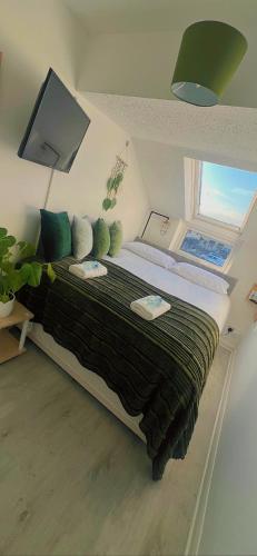 a bedroom with a large bed with a window at The Cosy Cumbrian Homestay in Penrith