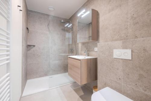 a bathroom with a shower and a sink at The Captainhouse in Nieuwpoort
