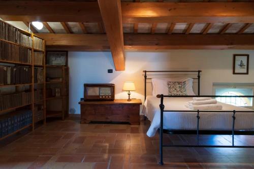 a bedroom with a bed and a table with a lamp at Villa Fiore in Novilara