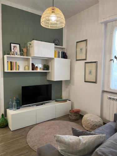 a living room with a white entertainment center with a tv at Casa Angiolina in Chiavari